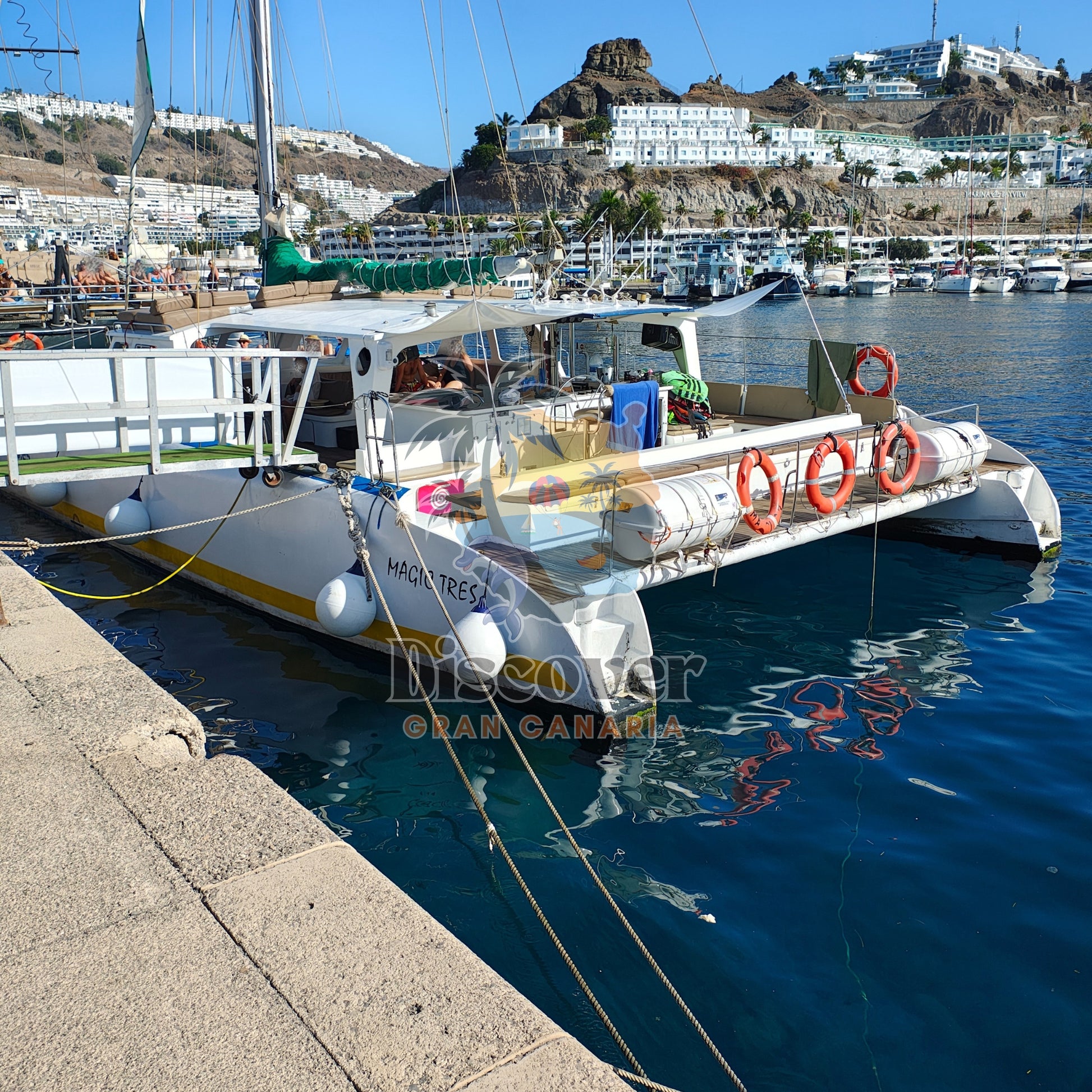 Boat docked at a harbor with scenic background