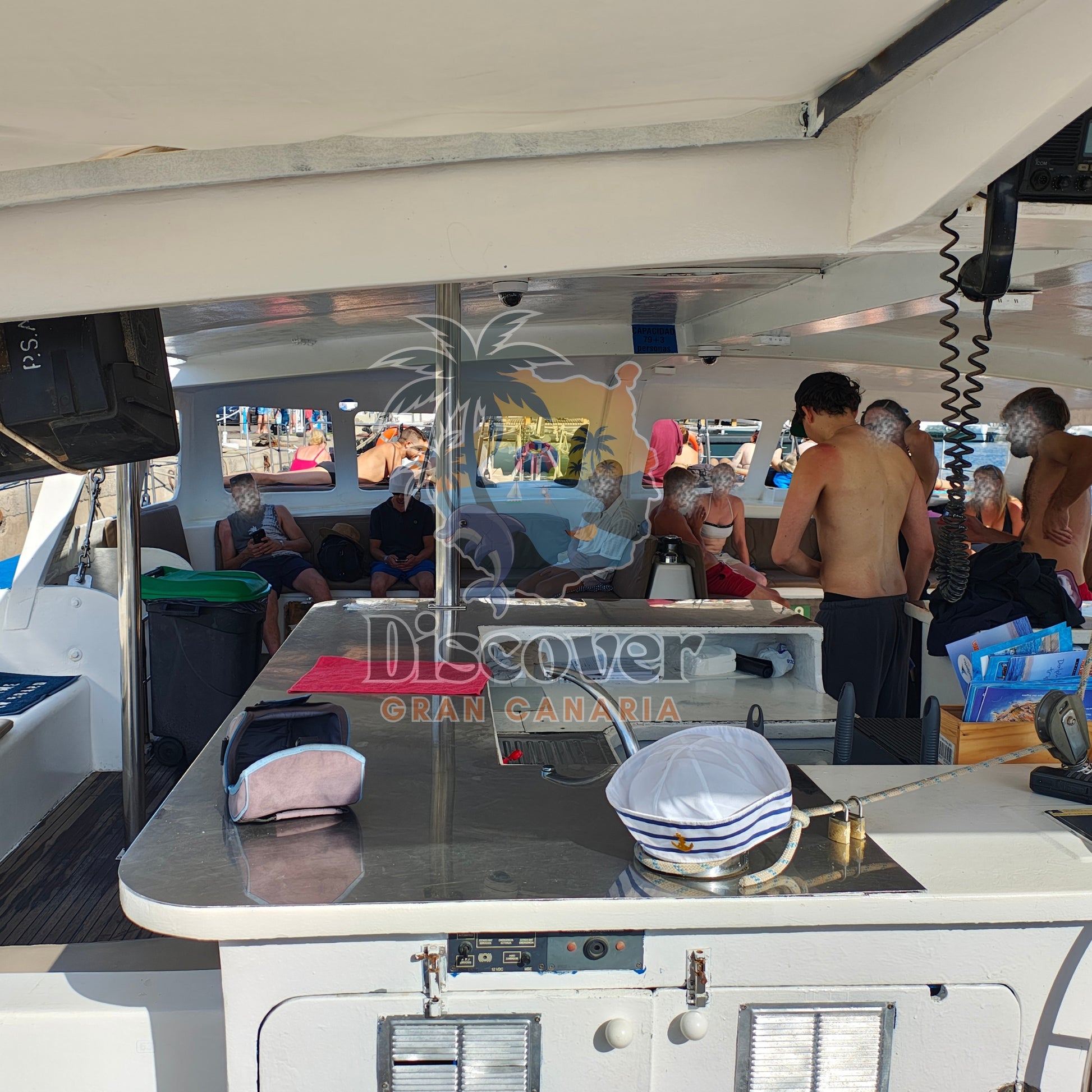 People on a boat with a 'Discover Gran Canaria' sign in the background
