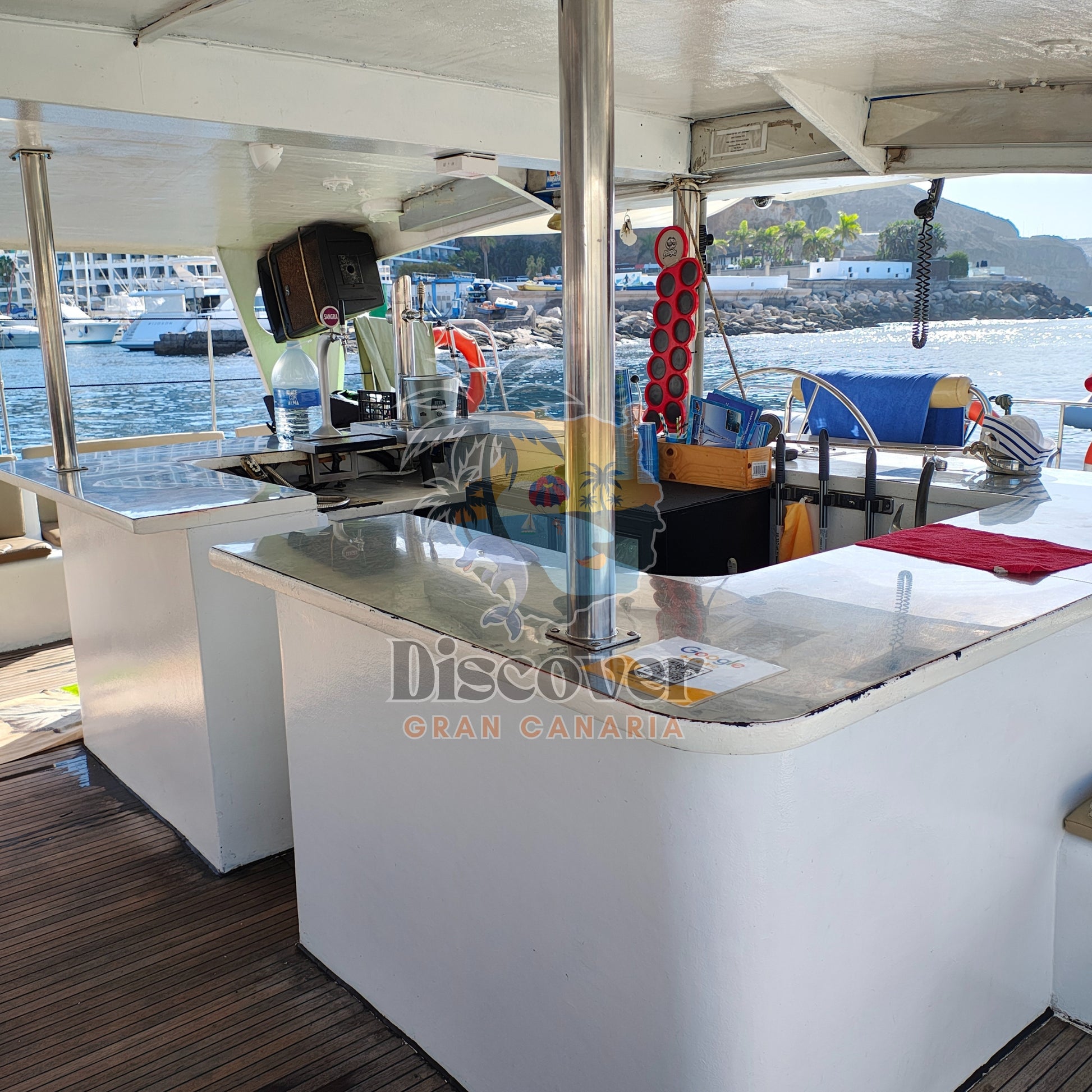 Yacht interior with a bar area and 'Discover Gran Canaria' branding.