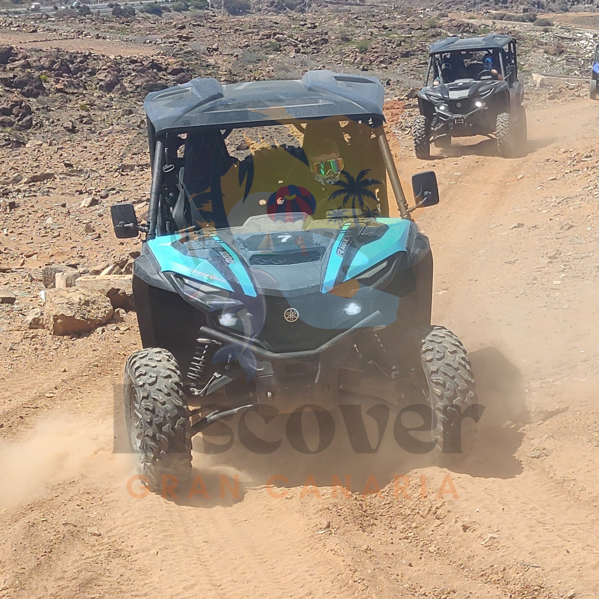 Two off-road vehicles driving on a dirt track with 'Discover Gran Canaria' branding.