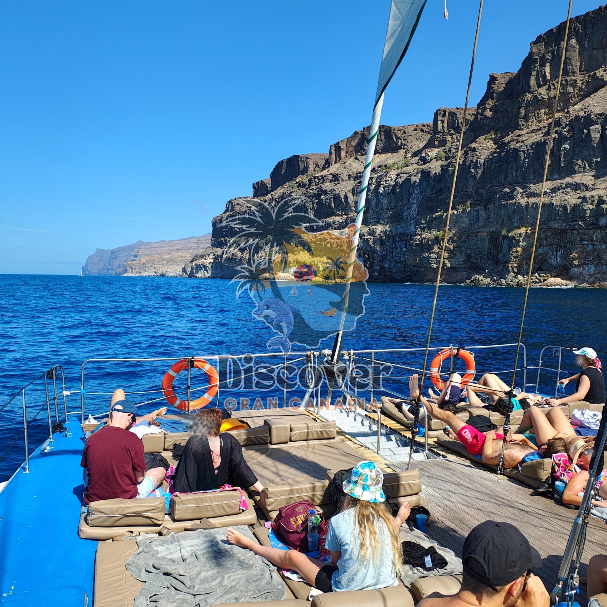 People on a boat with scenic cliffs and ocean view