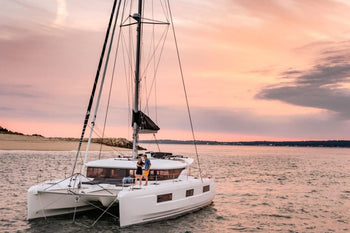 2 people on a private catamaran at the sunset