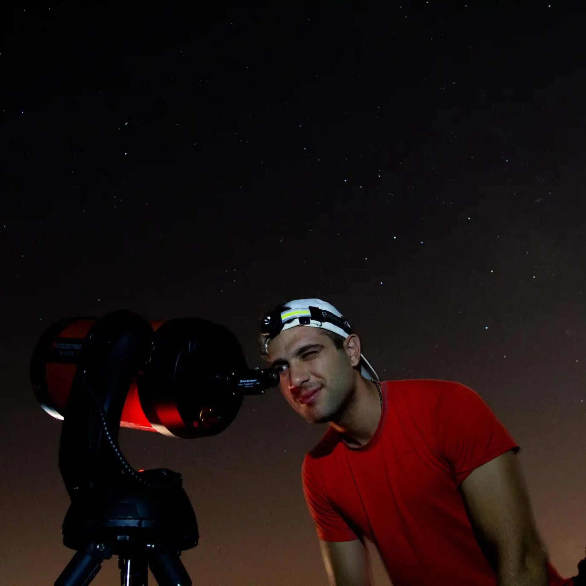 Sunset & Stargazing Tour in Gran Canaria participant using a telescope to observe stars at night.