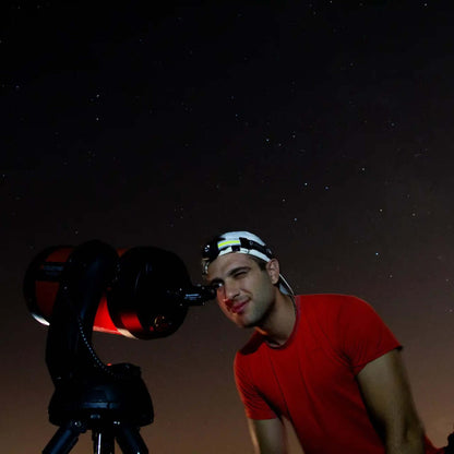 Sunset & Stargazing Tour in Gran Canaria participant using a telescope to observe stars at night.