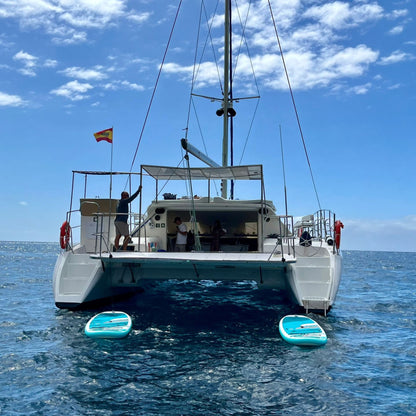 Paradise Catamaran Gran Canaria sailing on the ocean with a clear blue sky