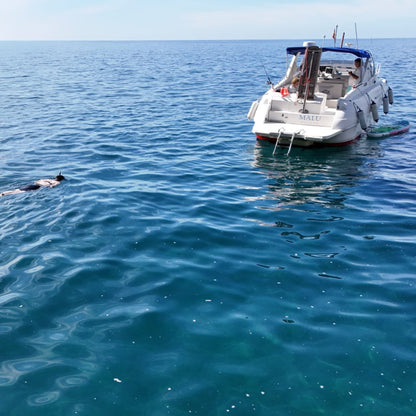 Gui Gui Yacht Tour Gran Canaria | Private & Shared Cruise boat in clear waters with swimmer