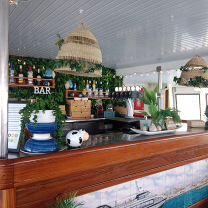 Princesa Ico All Inclusive Boat Trip Gran Canaria bar area with greenery and drinks.