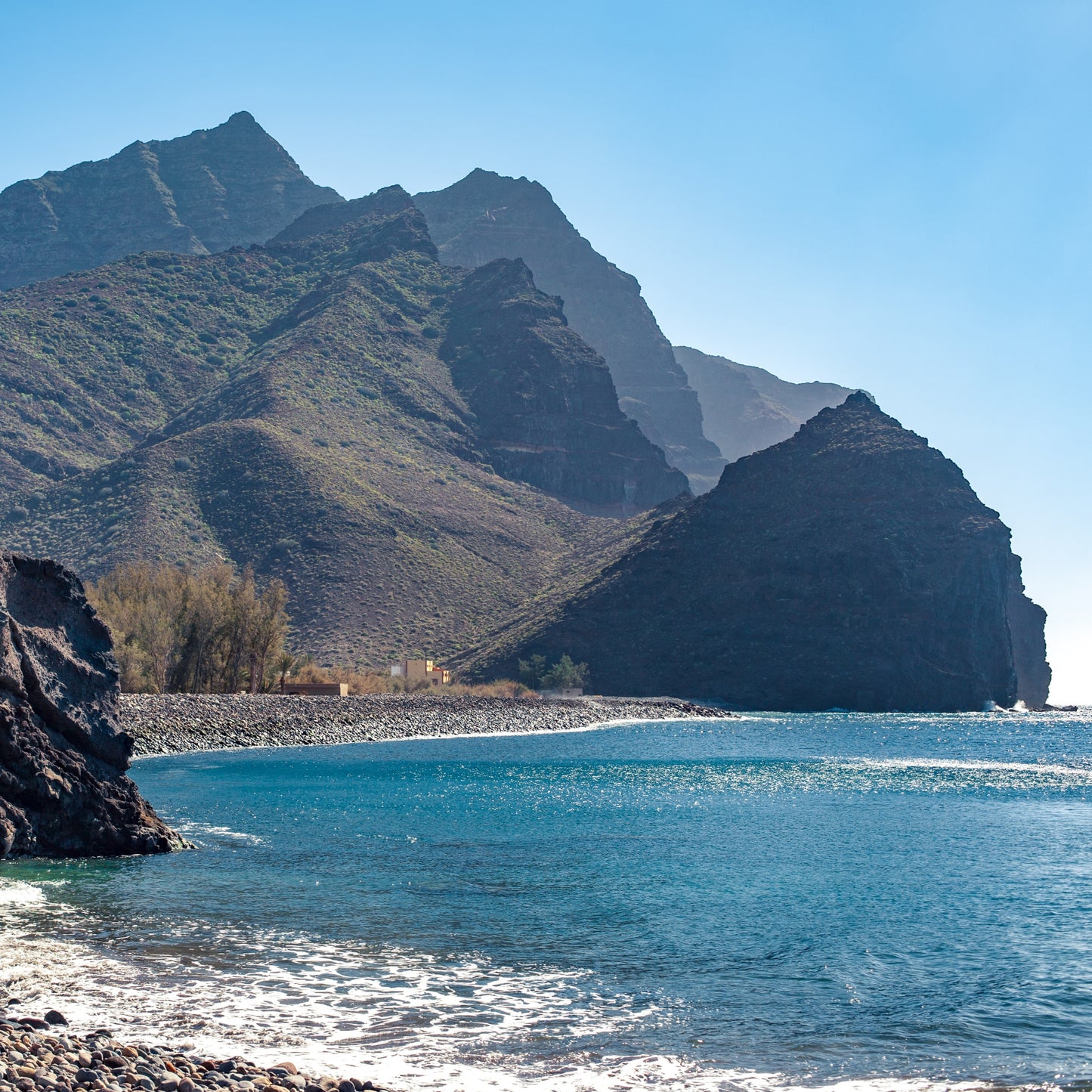 Stunning cliffs and crystal-clear waters near Gui Gui Yacht Tour Gran Canaria, showcasing natural beauty on the excursion.