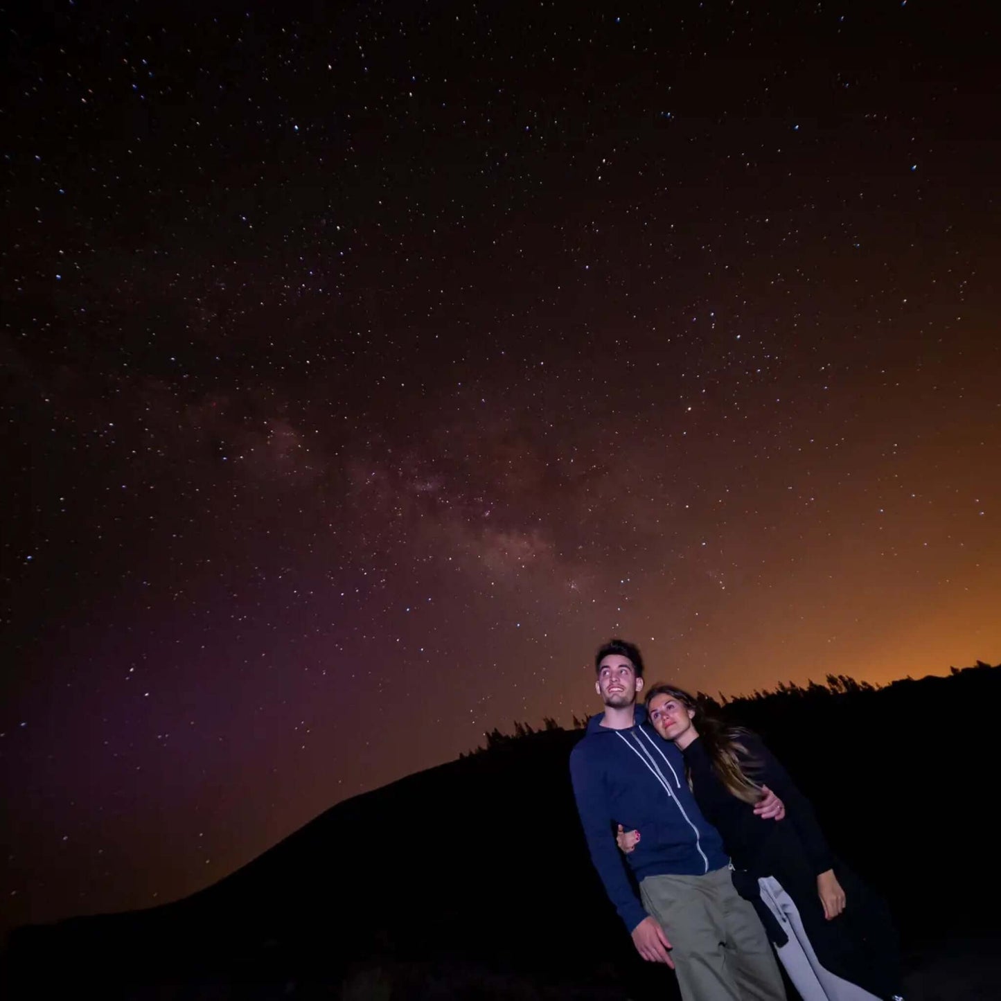 Couple enjoying the night sky during the Sunset & Stargazing Tour in Gran Canaria.