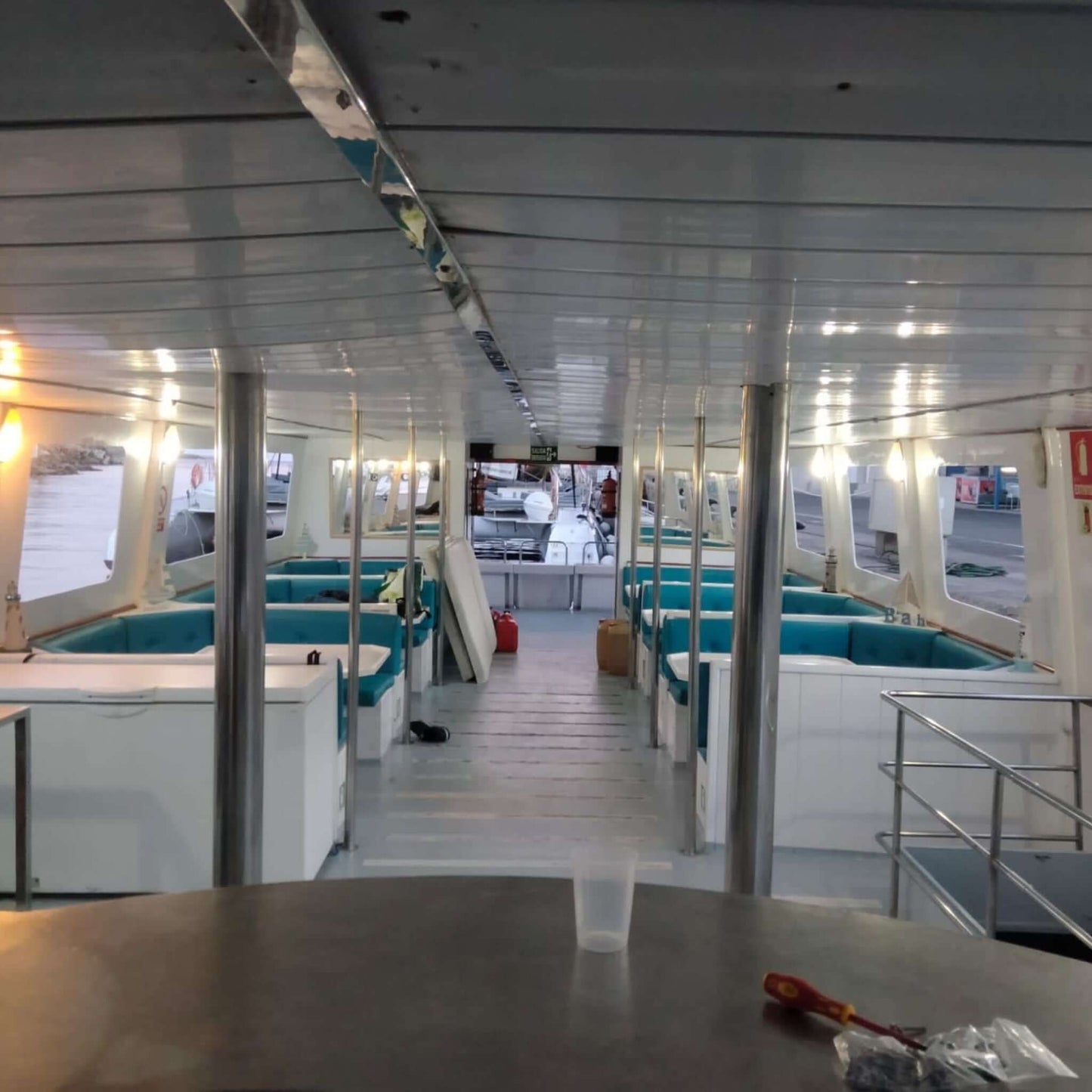 Interior view of the Princesa Ico All Inclusive Boat Trip Gran Canaria featuring seating and bright lighting.